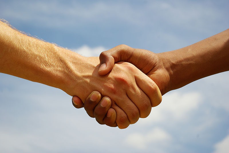 Two young businessmen shaking hands Two young businessmen shaking hands